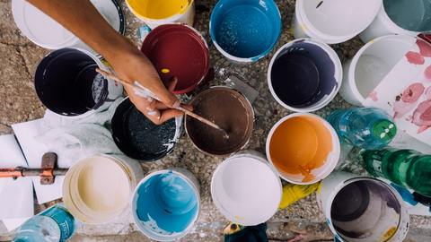 tins-of-paint-and-hand-with-paintbrush