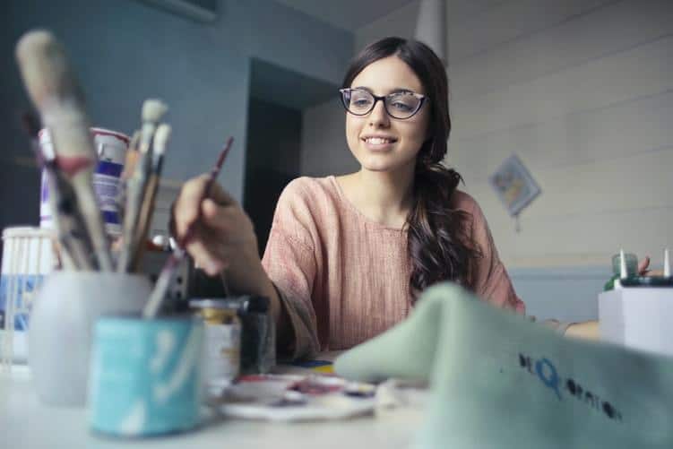 woman-in-glasses-painting-at-a-table